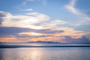 Beautiful beach sunset with blue sea and golden light sky  cloud background