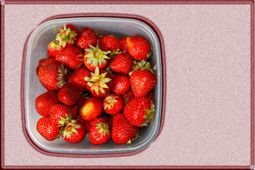 Strawberries in a square plastic tray on a beautiful background with copy space