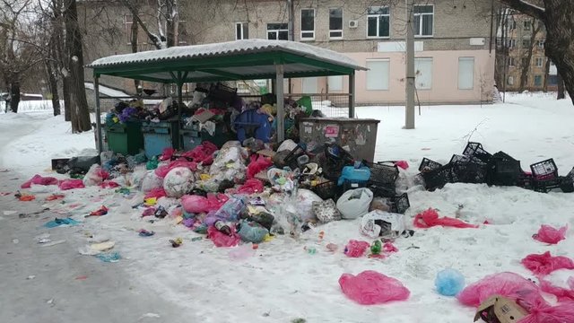 Overfilled garbage bins with rubbish bags