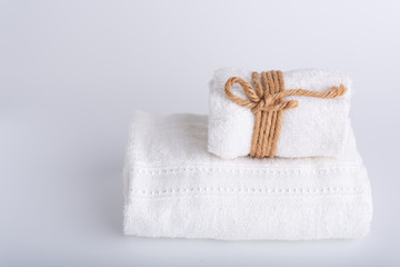 Fototapeta na wymiar Rolled white towels spa object on white background