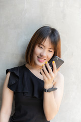 Happy Chinese teenager  girl talking mobile phone with smiling face