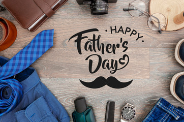 Top view men's accessories and clothes concept. Card with sign greeting text happy father's day