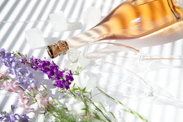 bottle of cold pink champagne ice flowers glasses summer morning