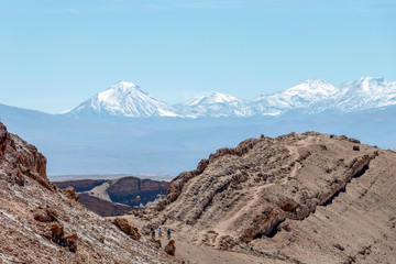 Moonlike landscape of dunes, rugged mountains and rock formations of Valle de la Luna (Moon valley), Atacama desert, Chile