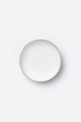 Empty white plate on white background, top view