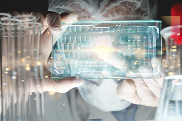 Portrait of futuristic researcher using the augmented reality screen with hologram graphics for...