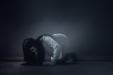 Ghost Woman Horror scene Death movie with Halloween Makeup lying on Floor in Darkroom. - obrazy, fototapety, plakaty