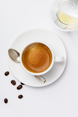 Cup of coffee on white background, top view
