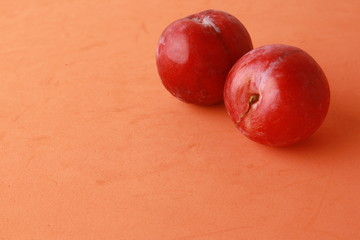 Delicious plums in colorful background