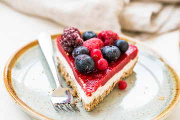 Berry cheesecake slice, fresh frozen red fruits and cheese cake slice, tasty dessert