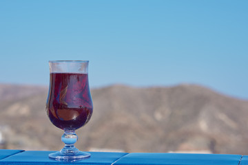 Wineglass with the red wine against relaxing view.