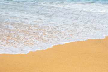 Soft wave of blue ocean on sandy beach , Summer day and sandy beach background with copy space.