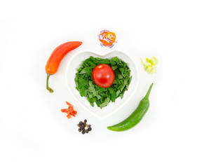 Flat lay mockup fresh vegetables on white background. Top view isolated onion, pepper and tomato on heart shape plate