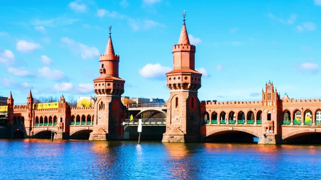 Berlin, Germany. View of Oberbaum bridge - a double-deck bridge over River Spree in Berlin, Germany during the sunny day in spring. Time-lapse with cloudy sky, zoom in