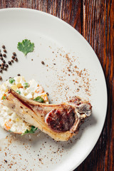 Steak of the lamb and salad on white plate.