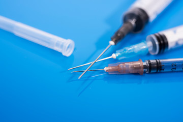 Vaccination time. Vaccine in vial with syringe on clock background. Prevention immunization illness.