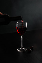 Red wine is poured into a glass