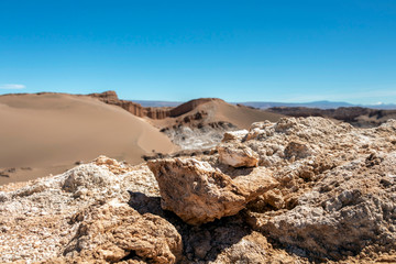 Moonlike landscape of dunes, rugged mountains and geological rock formations of Valle de la Luna (Moon valley) in Atacama desert, Chile
