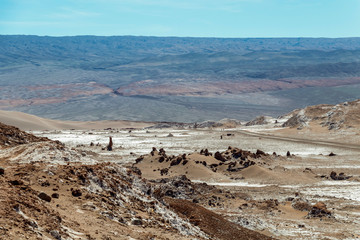 Moonlike landscape of dunes, rugged mountains and geological rock formations of Valle de la Luna (Moon valley) in Atacama desert, Chile