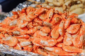 Pile of cooked shrimps at the market. Steet seafood