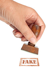 Genuine fake, rubber stamp. My hand with rubber stamp isolated on white. Business, politics or...