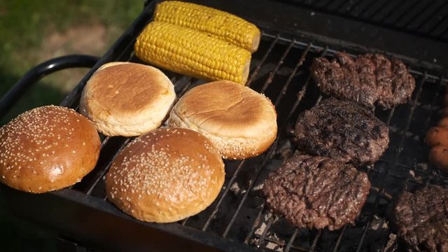 Mixed american barbecue food on hot grill
