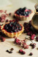 Sweet cupcakes with fresh organic strawberries on wooden table