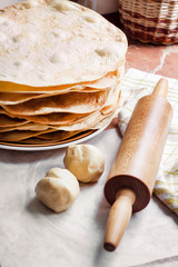 Cooking cake Napoleon - baked cake layers, raw dough and rolling pin