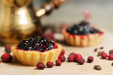 Sweet cupcakes with fresh organic strawberries on wooden table