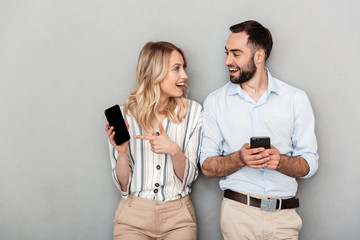 Attractive young couple standing isolated