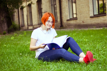 tired, tortured student doing homework near the university