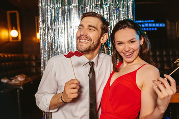 Fototapeta na wymiar Romantic young couple having fun in the night club. Man and woman in the pub.