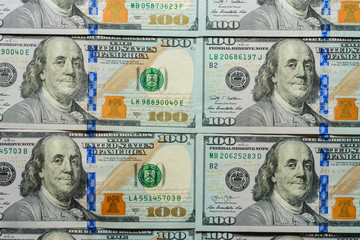 American dollars are put up in a row, a note worth a hundred dollars, a texture.