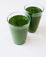 Freshly blended green smoothie with spinach, banana, spirulina, coconut milk and flax seeds . Healthy raw food