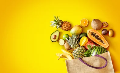 Fotobehang Variety of fresh tropical fruit on exotic yellow © exclusive-design