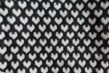 Top view of black wool with white hearts pattern