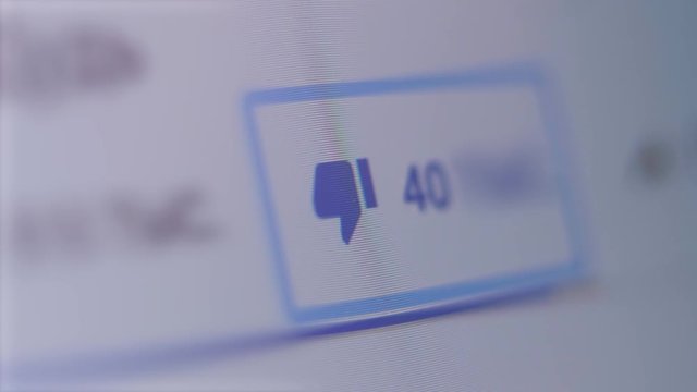 Close up shot of dislikes being counted on a social network page