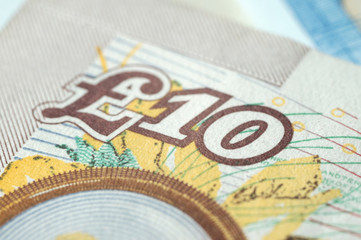 Obraz premium Fragment of ten pounds bills closeup. Shallow depth of field