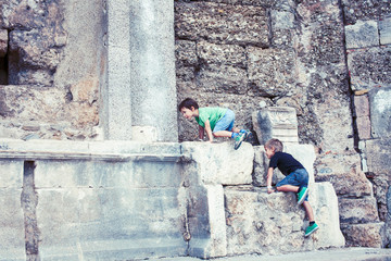Fototapeta na wymiar little boy exploring ancient architecture, lifestyle people on summer vacation close up