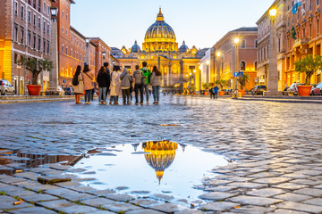 Vatican City by night. Illuminated dome of St Peters Basilica and St Peters Square. Group of...