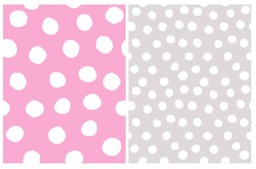 Cute Abstract Geometric Seamless Vector Patterns Set. Irregular Polka Dots Repeatable Design. White Dots on a Gray and Light Pink Backgrounds. Simple Dotted Layouts.