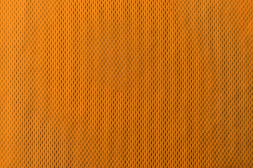 A uniformly lit orange fabric texture with soft shadows.