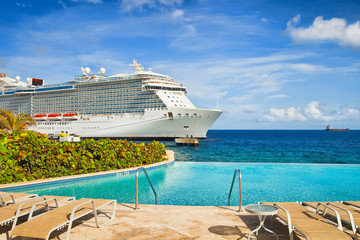 View from pool at tropical resort on cruise ship docked at port 