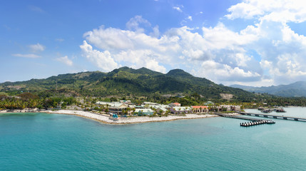 Fototapeta na wymiar Panorama of tropical resort Amber Cove with pier for cruise ships and resort on sunny day