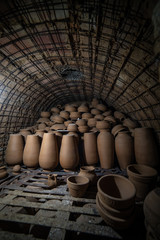 Lots of handmade mud pots inside old oven. Fray bentos, Uruguay. Handcrafts.
