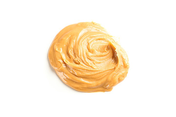 Creamy peanut butter isolated on white background. A traditional product of American cuisine