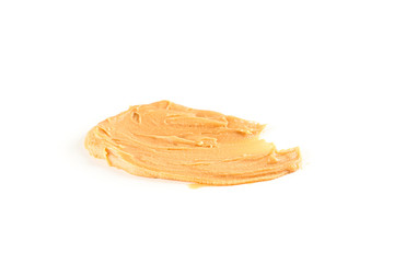 Creamy peanut butter isolated on white background. A traditional product of American cuisine