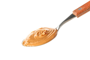 Creamy peanut butter in spoon isolated on white background. A traditional product of American cuisine