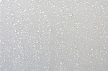 Surface and water droplets on a silver background