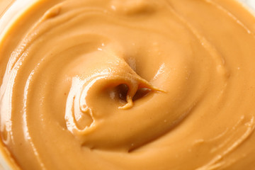 Peanut butter as background, space for text and closeup. A traditional product of American cuisine